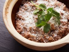 a wooden bowl filled with food and garnished with parsley