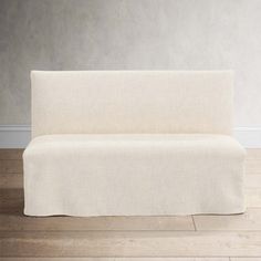 a white couch sitting on top of a hard wood floor