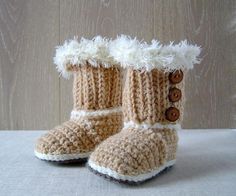 a pair of crocheted boots with buttons and fur lined up on a table