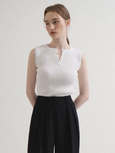 This is a minimal and modern top by VLETI that is made out of high quality and sturdy material. With distinctive mood of the design and comfortable wear, you can style it for your casual daily outfit.- Slim fitted sleeveless silhouette- Four buttons on the front- Minimal and feminine mood Chic White Vest For Everyday Wear, Chic White Vest For Everyday, Minimalist Sleeveless Top For Everyday, Casual Sleeveless Knit Top For Everyday, Chic Sleeveless Sweater Vest For Everyday, Versatile White Tank Top For Work, Minimalist Sleeveless Tank Top For Everyday, Chic Sleeveless Knit Top For Everyday, White Sweater Vest For Everyday Summer Wear