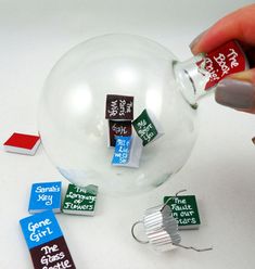 a person holding a glass ball with some magnets on it and other items around it