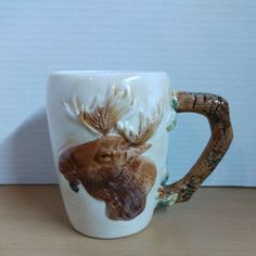 a ceramic mug with a moose head on it