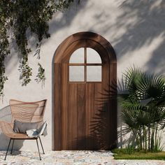 a chair sitting in front of a wooden door next to a potted palm tree