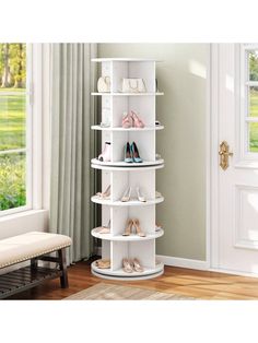 a white shelf with shoes on it in front of a window