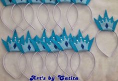 six crowns made out of blue paper are sitting on a white surface with the words arts by julia written below them