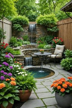 an outdoor garden with flowers and plants around the water feature, surrounded by a small waterfall