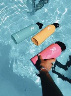 someone is holding their water bottle in the pool