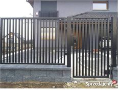 an iron gate is shown in front of a house