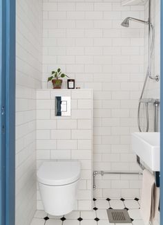 a white toilet sitting inside of a bathroom next to a shower