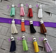 several colors of tassels are shown on a purple ribbon with the numbers six to eight