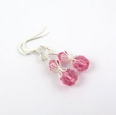 These beautiful pink earrings are created with rose pink Swarovski crystal element beads and beautiful silver bead caps. The earrings are composed of silver plated components. These pink drop crystal earrings are lightweight and great for anyone who loves pink. They come in a cute organza bag. See the matching necklace via the link below. LENGTH: about 1 & 1/2 inches total (top of ear wire to end of lowest bead) Matching pink bead necklace: https://www.etsy.com/listing/201854945/pink-necklac Handmade Pink Crystal Earrings In Sterling Silver, Handmade Pink Crystal Sterling Silver Earrings, Pink Crystal Ear Wire Earrings For Gift, Pink Sterling Silver Crystal Earrings As Gift, Handmade Pink Crystal Earrings, Pink Dangle Crystal Earrings With Faceted Beads, Pink Sterling Silver Crystal Earrings Nickel Free, Nickel-free Pink Crystal Earrings In Sterling Silver, Elegant Pink Beaded Earrings With Faceted Beads