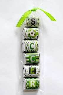 four chocolate bars wrapped in cellophane with green ribbon