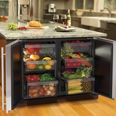 a kitchen with an island and refrigerator in it