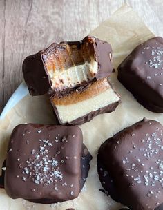 several pieces of chocolate covered dessert sitting on top of a white plate next to each other