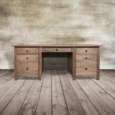 an old wooden desk sitting on top of a hard wood floor next to a wall