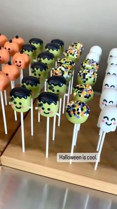 there are many halloween cake pops on the stick with sprinkles and faces