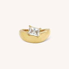 a gold ring with a square cut diamond