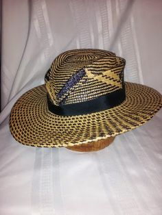 This style is made in hand woven panama straw which gives UV sun protection.  The style can made in this black and natural or brown and natural in this pattern, or a solid color as well. Contact me for available colors. The crown has two hand sculpted tear drop shaped ridges. The brim is slightly narrower in the back which adds to the feminine profile of the hat. The trim is hatband 1" black grosgrain ribbon. This style is functional and beautiful with a nice nod to a vintage silhouette and a mo Handwoven Toquilla Straw Fedora Panama Hat, Artisan Woven Fedora Panama Hat, Woven Straw Panama Hat With Flat Brim, Artisan Toquilla Straw Fedora Panama Hat, Brown Woven Fedora Straw Hat, Brown Woven Straw Fedora, Handwoven Toquilla Straw Panama Hat, Handwoven Toquilla Straw Fedora, Artisan Toquilla Straw Panama Fedora Hat