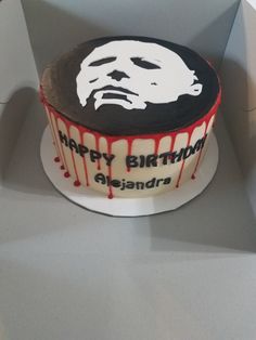 a birthday cake decorated with an image of a man's face and dripping blood