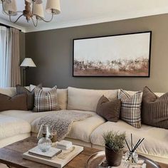 a living room filled with lots of furniture and pillows on top of a wooden table