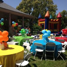 an outdoor party with balloons and decorations