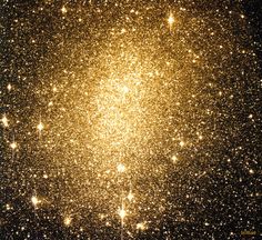 an image of some gold glitter in the night sky with stars all over it, as if they were from outer space