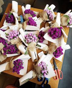 purple flowers are wrapped in burlocks and tied with twine on the table