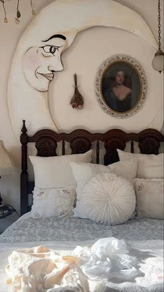 there is a bed with white sheets and pillows in the room that has paintings on the wall