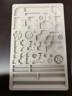 a white plastic mold that looks like it is made out of various parts and shapes