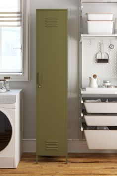 a green locker next to a washer and dryer in a white laundry room