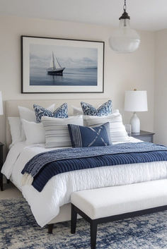 a bedroom with a large bed covered in blue and white pillows