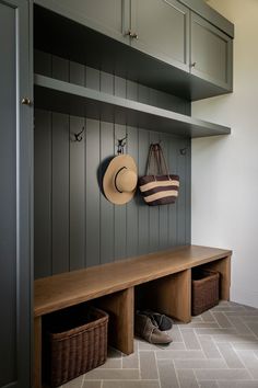 Herringbone tile floors in a cozy mudroom space. Mudroom Slate Floor, Mudroom High Ceiling, L Mudroom, Mud Area Ideas, Entry Mudroom Ideas Modern, Tiled Mudroom Floor, Black Cabinet Mudroom, Mountain Home Mudroom, Mudroom With Lockers And Bench