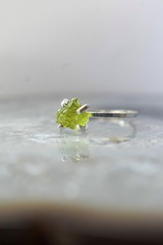 ---------------------------------------------------- Raw Peridot Ring. THE PRODUCT - This is a gorgeous raw Peridot ring - Each ring is handmade by myself and is for the person who truly enjoys the look of a real peridot and admires it's beauty straight from nature. - These stones have not been treated in anyway so each stone will be unique in shape, color, and size - The shades of each stone vary since they are natural and untreated. If you have a shade preference, please indicate it in the not Green Peridot Stackable Promise Rings, Green Peridot Stackable Rings, Green Peridot Birthstone Ring, Dainty Style, Dainty Green Peridot Rings, Raw Peridot, August Birthstone Ring, Green Gemstone Ring, Rough Gems, Nice Jewelry