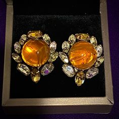 Vintage Signed Schreiner New York Brillant Rhinestone Cluster Clip-on Earrings! Round glass faux amber cabochon center surrounded by clear sparkly marquise crystal pronged stones, very sparkly!  *Note: one of the back of the earrings has been repaired, see photo. Offers considered! For some history on jewelry artist Henry SCHREINER, you can read more here: https://www.antiquetrader.com/collectibles/schreiner-costume-jewelry-sees-surge-in-demand-and-rise-in-values Antique Shopping, Initial Earrings, Luxury Diamonds, Heart Shaped Earrings, Square Earrings Studs, Rainbow Earrings, Knot Earrings, Cz Stud Earrings, Rhinestone Heart