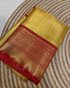 Golden yellow tissue silk saree with rich zari work and red border. The pallu is woven in red. The blouse piece is in red, same combination as the border and pallu. The saree is soft, drapes wonderfully, easy and comfortable to wear. It has a rich texture, and is suitable for ceremonies, parties and festivals. Goes really well with traditional earrings. Dimensions - 6.3m length, with 5.5m saree and 0.8m blouse piece in running material. Best quality. Red Saree Blouse Color Combinations, Red Saree With Golden Border, Yellow Tissue Saree, Red Saree Blouse, Tissue Silk Saree, Pattu Saree Blouse Designs, Tissue Saree, Saree Silk, Saree Designs Party Wear