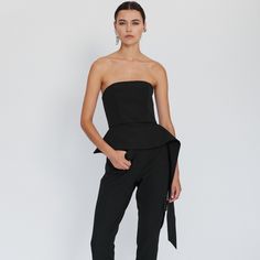 This strapless bustier has a corset-inspired shape that is fitted at the bodice.  It has a flattering peplum hem and a flowing panel at one side.  Its simplicity makes it incredibly easy to style. This seasonless piece is one of the wardrobe essentials.  It has a metal zipper closure at the back %64 Cotton %33 Nylon %3 Elastane Formal Fitted Strapless Jumpsuit, Fitted Strapless Jumpsuit For Cocktail Occasions, Fitted Strapless Jumpsuit For Date Night, Fitted Bandeau Strapless Jumpsuit For Date Night, Fitted Strapless Bandeau Jumpsuit For Date Night, Fitted Strapless Tube Top With Lined Bodice, Fitted Strapless Corset For Formal Occasions, Formal Fitted Strapless Corset, Chic Fitted Overbust Tube Top