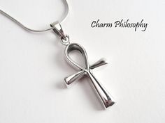 This ankh cross necklace, also known as the key of life, the key of the Nile or crux ansata, was the ancient Egyptian hieroglyphic character that read "life." It's made of 925 sterling silver. We recommend the curb link chain if this is being purchased for a male. The ankh necklace includes: - Ankh Pendant (measuring 26 x 16 mm) - A rope, snake, anchor or curb link chain (measuring 16 to 30 inches) ADD INITIAL CHARMS: https://etsy.me/3gMPv4r ADD BIRTHSTONE CHARMS: https://etsy.me/3gGTLT4 ADD BIRTHSTONE BEAD CHARMS: https://etsy.me/3gGltzv SILVER POLISHING CLOTH: https://etsy.me/3ieXQyh Looking for more sterling silver necklaces? Check out our collection: https://charmphilosophy.etsy.com ♥ PACKAGING ♥ Our necklaces come in a jewelry box with a jewelry card background. If you would like a cu Egyptian Hieroglyph, Ancient Egyptian Hieroglyphics, Afrocentric Jewelry, Ankh Pendant, Key Of Life, Ankh Cross, Ankh Necklace, Egyptian Hieroglyphics, The Nile