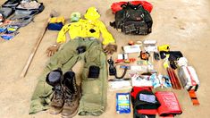 a man laying on the ground surrounded by camping gear and items to pack for a trip