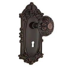 an ornate door handle with a keyhole on the front and back side of it