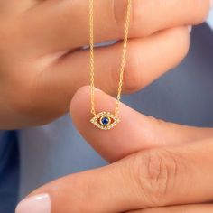 14k Gold and diamond evil eye necklace with sapphire, ruby and emerald center stone options. Diamond: 0.10 ct diamond Charm Measurements: 10 mm x 5 mm ( 0.4 inch. x 0.5 inch ) Chain: 1.1 mm link chain Chain length: 14+2 or 16+2 inch options ( Please let us know if you want a different length) Color: G Quality: SI-VS Additional Notes: * Non-Conflict Diamonds * Made in the USA C U R R E N T ∙ T U R N A R O U N D Processing Time: 1-2 weeks Within United States: approx. 3-5 biz days (faster shipping Spiritual Cubic Zirconia Gemstone Necklace, Spiritual Gemstone Necklace With Cubic Zirconia, Yellow Gold Eye Necklaces With Diamond Eyes, Fine Jewelry Necklace With Diamond Eyes For Gift, Fine Jewelry Necklaces With Diamond Eyes For Gifts, Yellow Gold Jewelry With Diamond Eyes For Gifts, Fine Jewelry Featuring Evil Eye, Diamond Evil Eye Jewelry In Yellow Gold, Yellow Gold Diamond Evil Eye Jewelry