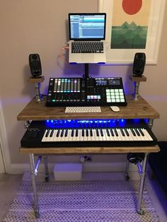 a laptop computer sitting on top of a wooden desk next to a keyboard and mouse