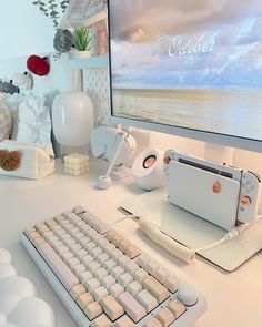 a desktop computer sitting on top of a white desk next to a keyboard and mouse