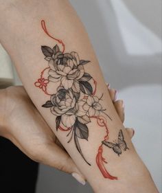 two women with tattoos on their arms holding onto each other's hands and one has a butterfly