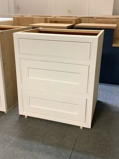 an unfinished kitchen cabinet is shown in the process of being assembled and painted with white paint