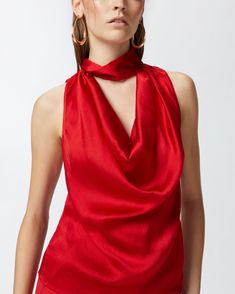 Sleeveless top in slightly crinkly satin fabric. The draping on the front creates a plunging neckline. High neck and buttoned keyhole fastening in the middle at the back. Chic Party Tops With Gathered Neckline, Sleeveless Silk Top With Ruched Detail, Sleeveless Ruched Silk Top, Sleeveless Silk Ruched Top, Red Silk Sleeveless Top, Calf Length Skirts, Satin Top, Casual Blazer, Mid Dresses