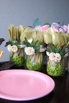 there are many flowers in mason jars on the table