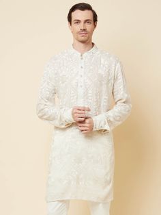 This Lucknowi kurta will instantly give an elegant look. Made from polyester cotton fabric, this 2 piece kurta set features a white lucknowi kurta, front buttons fastening, designer cuff buttons, and a mandarin collar. This lucknowi kurta has beautiful chikankari embroidery work all over. It is paired with white churidar pants. An ideal outfit for traditional & special events.

Size Chart For Men





	
	
					Men's Size Chart
		

		
		
						
				Size Chart For Men
				Custom Size Measurement G Cotton Kurta In Off White With Naqshi Detail, Off White Cotton Kurta With Naqshi Detailing, Off White Straight Kurta For Diwali, Diwali Off White Straight Kurta, Traditional Fit White Sherwani With Long Sleeves, Off White Naqshi Kurta For Diwali, White Traditional Fit Long Sleeve Sherwani, White Long Sleeve Sherwani In Traditional Fit, Cream Long Sleeve Kurta With Naqshi