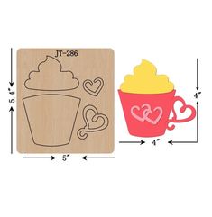 a rubber stamp with a cupcake and heart shaped shapes on it, next to a wooden