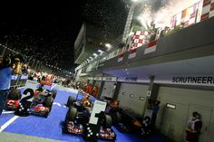 red bull racing cars are on display at the singapore grand prix in 2012, with fireworks and confetti thrown over them