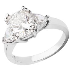 a white gold ring with three pear shaped diamonds